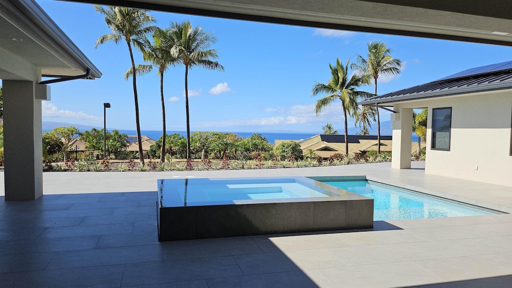 view of swimming pool featuring an in ground hot tub and a patio area