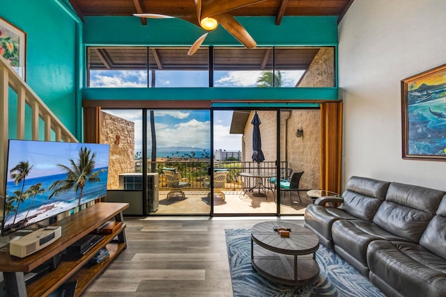 living room with wood ceiling, ceiling fan, beamed ceiling, and wood-type flooring