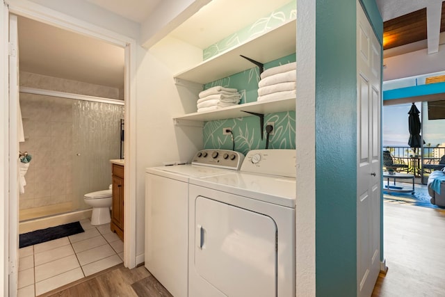 laundry room featuring washer and clothes dryer and light hardwood / wood-style floors