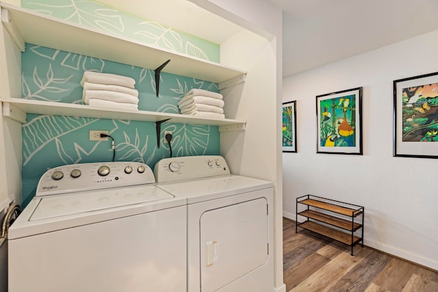 laundry room featuring light wood-type flooring and washer and dryer