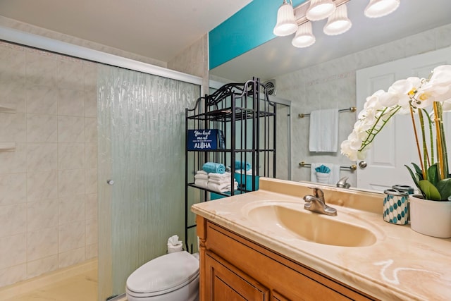 bathroom featuring vanity, toilet, and an enclosed shower