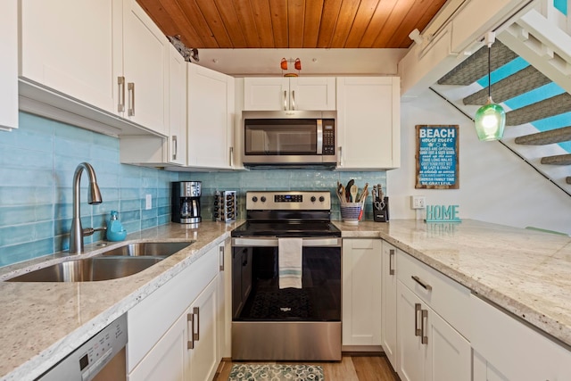 kitchen with wood ceiling, backsplash, light stone counters, sink, and appliances with stainless steel finishes