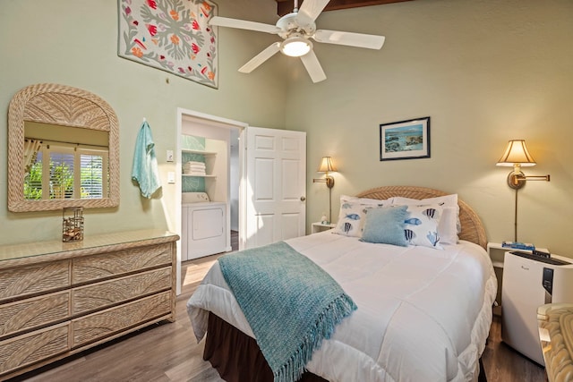 bedroom with a high ceiling, ceiling fan, and hardwood / wood-style flooring