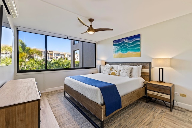 bedroom with wood-type flooring and ceiling fan