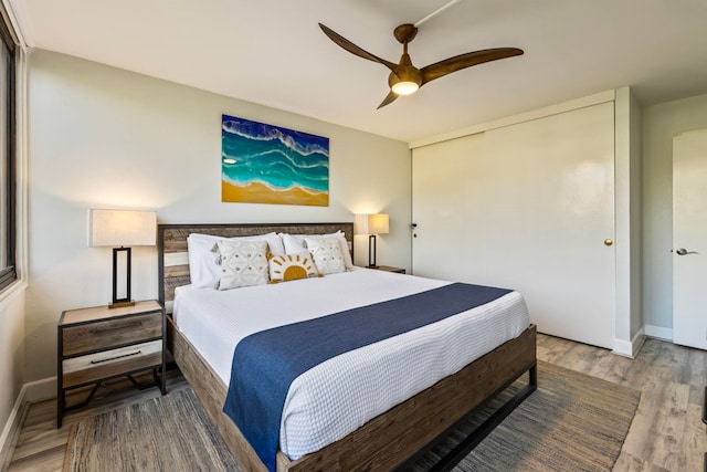 bedroom with ceiling fan and wood-type flooring