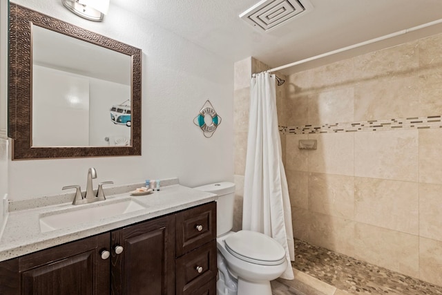 bathroom with vanity, toilet, and curtained shower