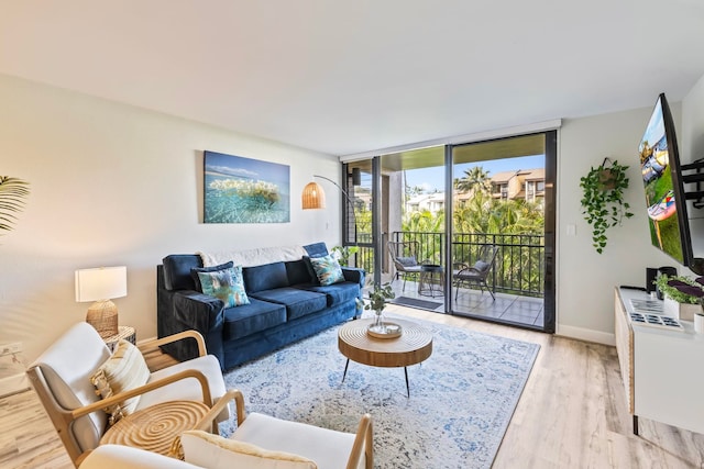 living room with light hardwood / wood-style flooring and floor to ceiling windows