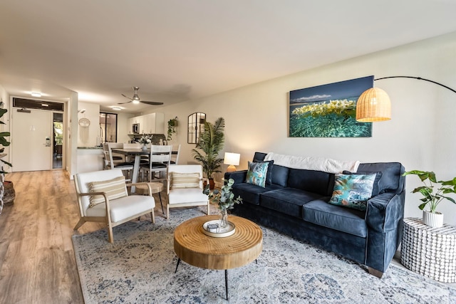 living room featuring ceiling fan and hardwood / wood-style floors