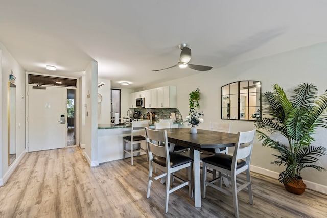 dining room with light hardwood / wood-style floors and ceiling fan