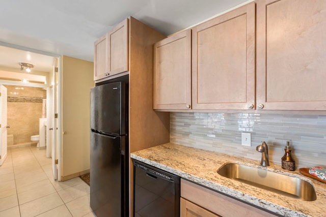 kitchen with decorative backsplash, light brown cabinets, black appliances, and sink