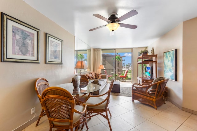 tiled dining space featuring ceiling fan and a wealth of natural light