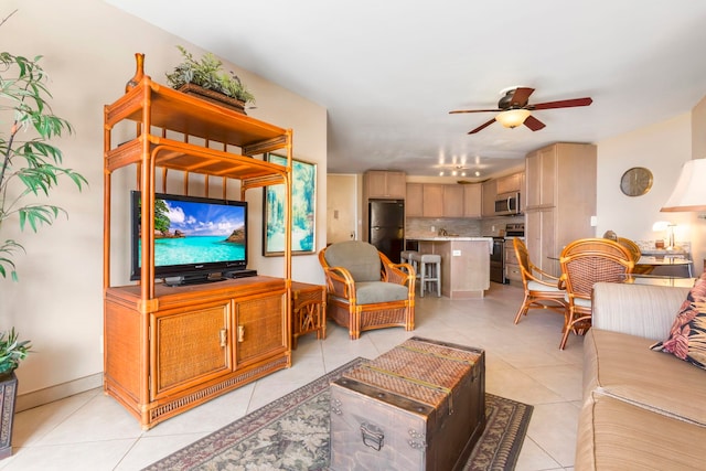 tiled living room featuring ceiling fan