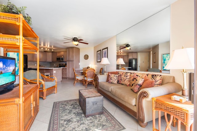 tiled living room with ceiling fan