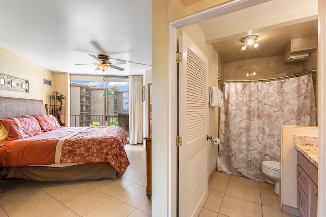 tiled bedroom with ceiling fan and access to exterior