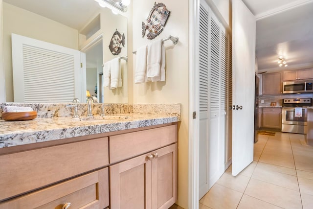 bathroom featuring tile patterned flooring and vanity