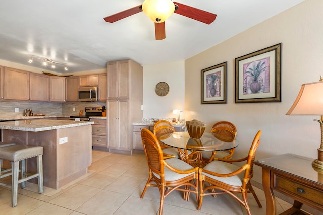 dining room featuring ceiling fan and light tile patterned flooring