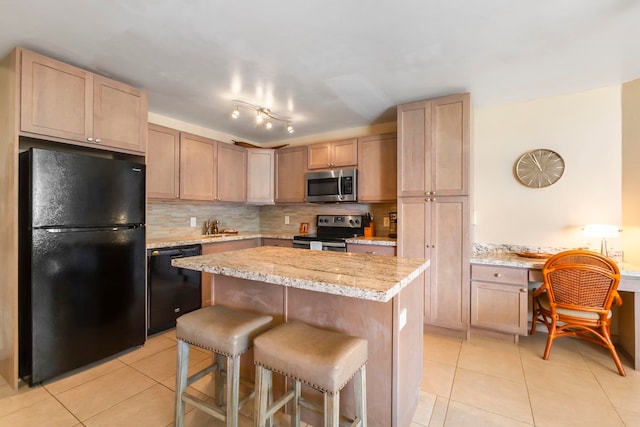 kitchen featuring light brown cabinets, black appliances, light stone countertops, tasteful backsplash, and light tile patterned flooring