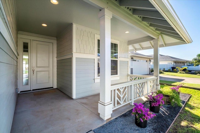 entrance to property with a garage and a porch