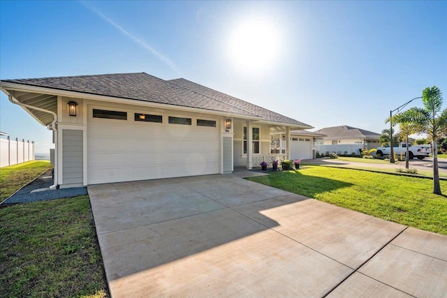 ranch-style house featuring a garage and a front yard