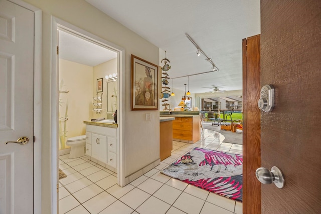 interior space with light tile patterned floors and rail lighting