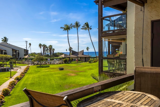 view of yard featuring a balcony and a water view