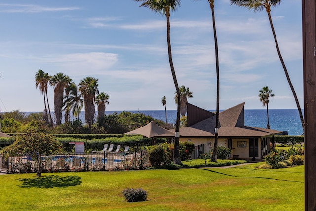 exterior space featuring a front lawn and a water view