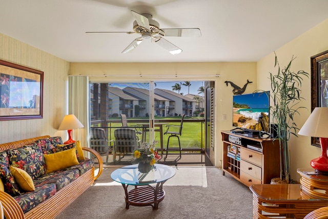 living room with ceiling fan and carpet