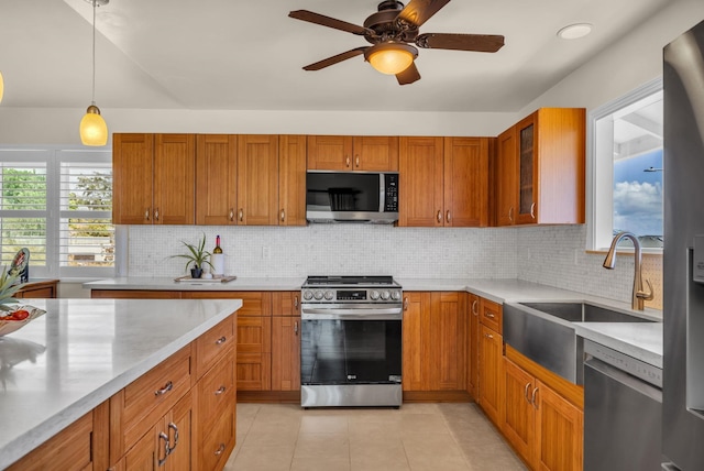 1363 Owaka St, Wailuku, HI 96793 - kitchen with stainless steel appliances, light countertops, brown cabinetry, and tasteful backsplash