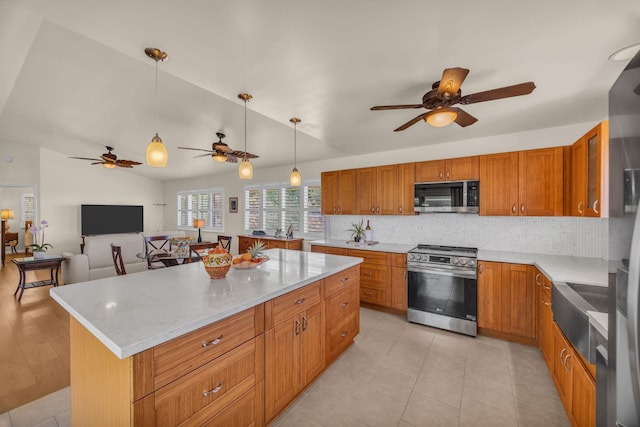 1363 Owaka St, Wailuku, HI 96793 - kitchen with stainless steel appliances, a ceiling fan, tasteful backsplash, brown cabinets, and vaulted ceiling