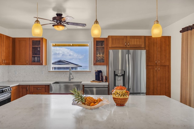 1363 Owaka St, Wailuku, HI 96793 - kitchen with stainless steel appliances, brown cabinetry, and decorative backsplash
