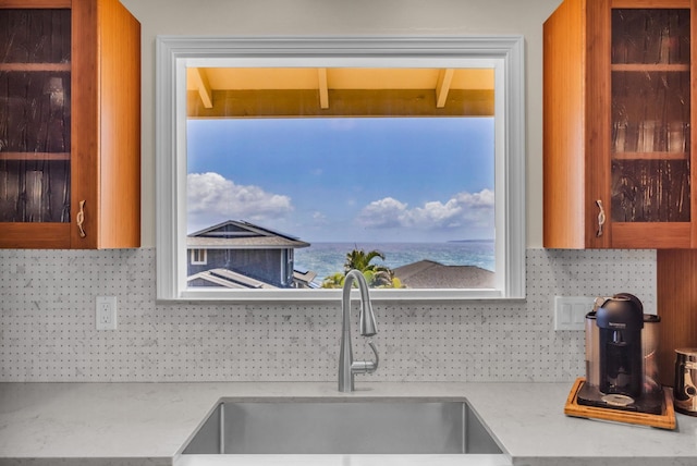 1363 Owaka St, Wailuku, HI 96793 - kitchen with decorative backsplash, brown cabinetry, and a water view