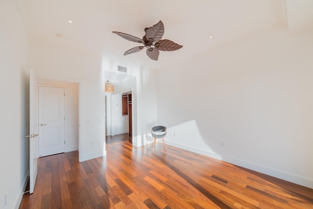 empty room with dark hardwood / wood-style floors and ceiling fan