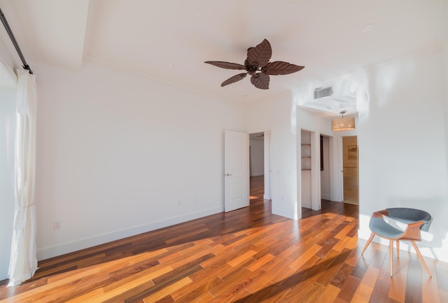 empty room with ceiling fan and wood-type flooring