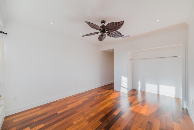 unfurnished room featuring wood-type flooring, ceiling fan, and ornamental molding