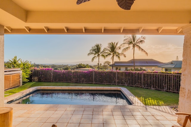 view of swimming pool featuring a lawn, a patio area, and ceiling fan