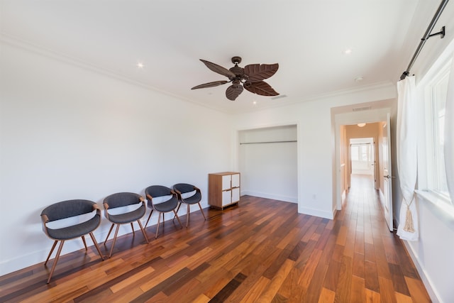 interior space with dark hardwood / wood-style flooring, ceiling fan, and ornamental molding