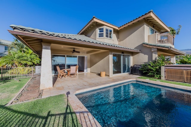 rear view of house featuring a fenced in pool, ceiling fan, a balcony, and a patio