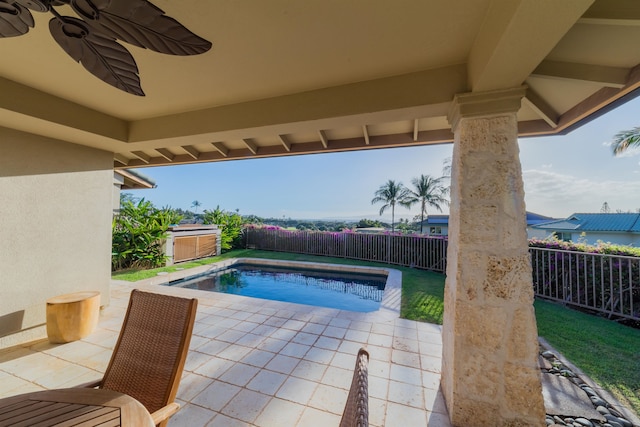 view of pool with ceiling fan and a patio