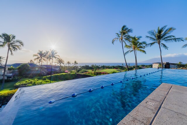 view of pool at dusk