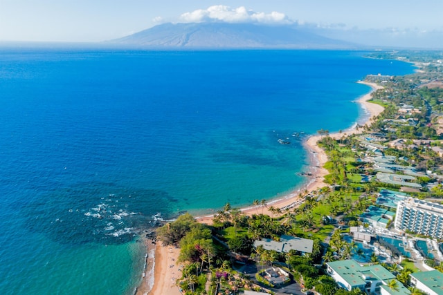 drone / aerial view featuring a water view and a beach view