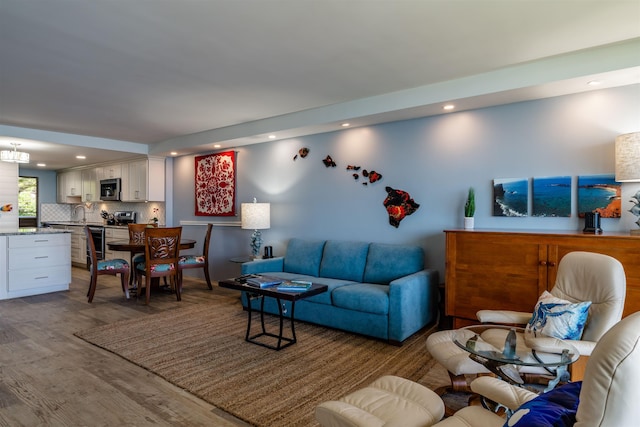 living room with recessed lighting and wood finished floors