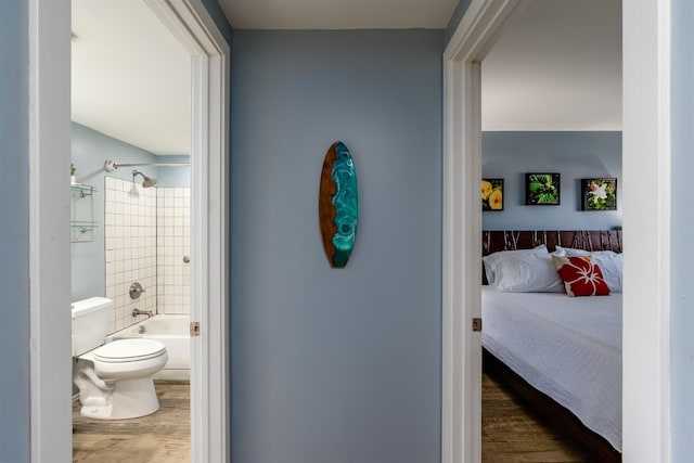 interior space with connected bathroom and wood finished floors