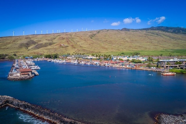 drone / aerial view featuring a water and mountain view