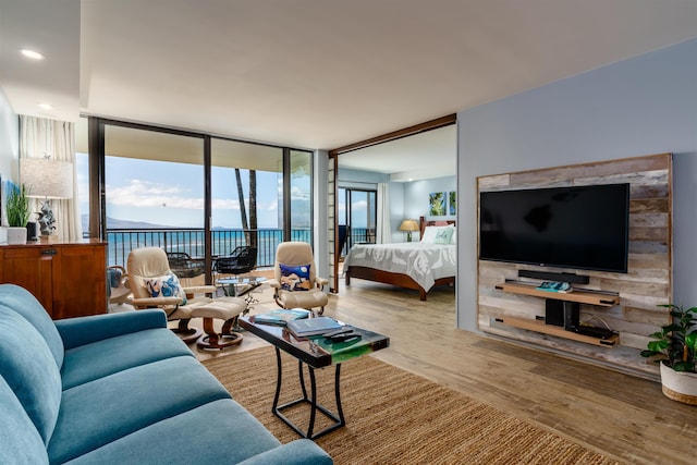 living room with floor to ceiling windows and wood finished floors