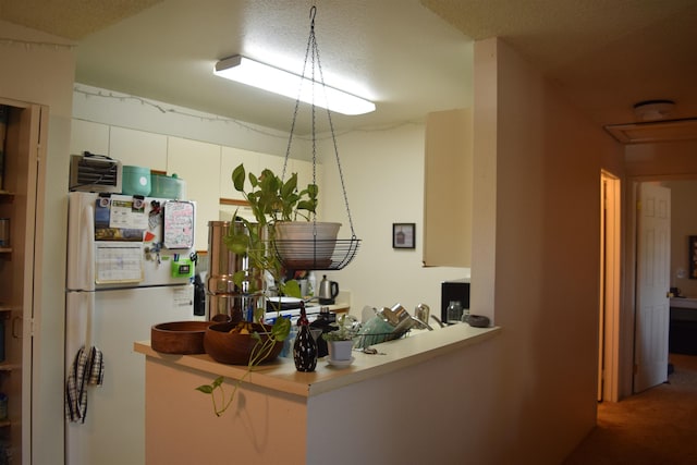 140 Uwapo Rd Unit 41-203, Kihei, HI 96753 - kitchen with freestanding refrigerator, carpet flooring, and white cabinetry