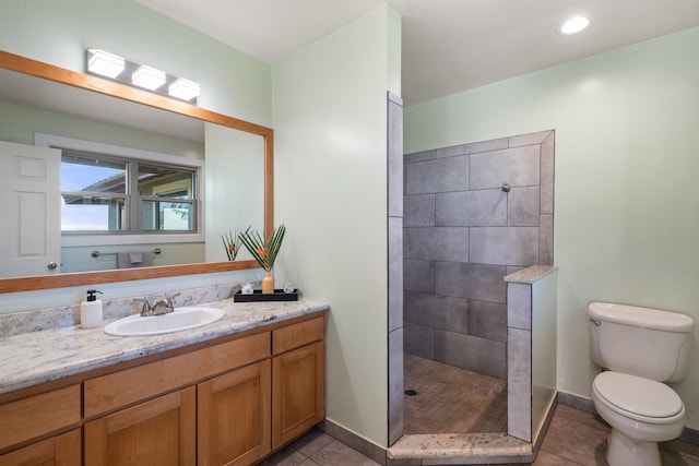 full bath with toilet, vanity, a walk in shower, tile patterned flooring, and baseboards