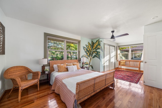 bedroom with hardwood / wood-style flooring, a closet, and a ceiling fan