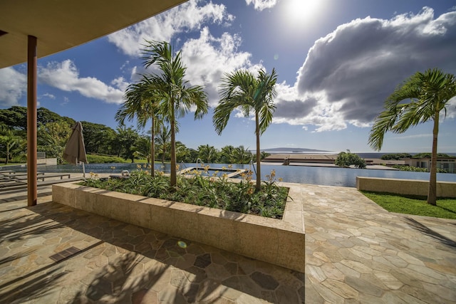 view of patio featuring a water view