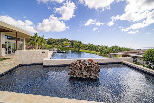 view of pool with a water view