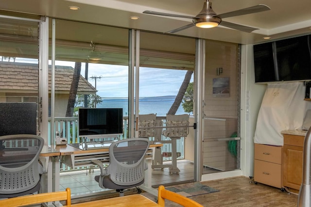 interior space with ceiling fan